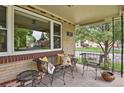 Inviting covered porch with comfortable seating, perfect for relaxing and enjoying the neighborhood views at 1600 Olive St, Denver, CO 80220