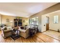 Cozy living room featuring hardwood floors, ample natural light, and comfortable seating at 1600 Olive St, Denver, CO 80220