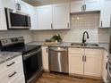 Modern kitchen featuring stainless steel appliances, white cabinets, granite countertops, and subway tile backsplash at 2510 Kenton, Aurora, CO 80010