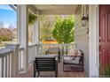 Cozy front porch features comfortable seating, a hanging plant, and a charming outdoor ambiance at 3476 Beeler Ct, Denver, CO 80238