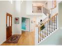 Spacious foyer with wood floors, staircase with black iron railings, and plenty of natural light at 469 Tripp Dr, Golden, CO 80401
