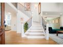 Bright foyer features hardwood floors, modern staircase and decor at 469 Tripp Dr, Golden, CO 80401