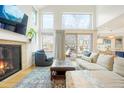 Cozy living room with fireplace, plush seating, and natural light from large windows and sliding glass doors at 469 Tripp Dr, Golden, CO 80401