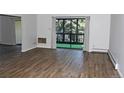 Spacious living room with wood-look floors and access to the balcony at 14152 E Linvale Pl # 311, Aurora, CO 80014