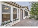 Home exterior featuring wooden deck and door with flower boxes and natural light at 1062 Pinon Ln, Elizabeth, CO 80107