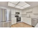 Modern kitchen with stainless steel appliances, granite counters, and ample white cabinets at 13992 E Marina Dr # 109, Aurora, CO 80014