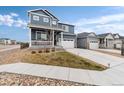 Charming two-story home featuring a covered porch, attached two car garage and mature landscaping at 2186 Prairie Smoke Dr, Monument, CO 80132