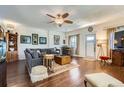 Open-concept living room featuring hardwood floors, and an entertainment area, creating a comfortable and inviting atmosphere at 1559 Elm St, Denver, CO 80220