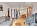 Living room with hardwood floors and a view of the dining area at 2895 Poplar St, Denver, CO 80207