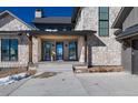 Inviting entryway with stone facade and double doors at 2442 Fox View Trl, Franktown, CO 80116