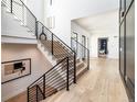 Modern light-wood staircase with metal railings at 2442 Fox View Trl, Franktown, CO 80116