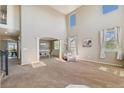 Open-concept living room with high ceilings flowing seamlessly into the adjacent dining area, offering spacious living at 42311 Forest Oaks Dr, Elizabeth, CO 80107