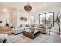 Bright living room showcases a large sectional sofa, modern lighting, and views of the outdoors at 3649 W 21St Ave, Denver, CO 80211