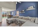 Stylish living room with a striking blue accent wall, comfortable seating, and modern decor at 265 N Holcomb St, Castle Rock, CO 80104