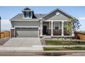 Charming single-Gathering home with a two-car garage, inviting front porch and manicured lawn at 9069 Pitkin St, Commerce City, CO 80022