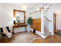 Elegant foyer with hardwood floors, ornate mirror, staircase, and decorative lighting fixtures at 1267 Clayton St, Denver, CO 80206