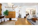 Bright living room featuring hardwood floors, white walls, staircase, and decorative lighting at 1267 Clayton St, Denver, CO 80206