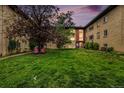 Cozy apartment building featuring a manicured lawn and inviting outdoor seating under a beautiful dusk sky at 665 Washington St # 5B, Denver, CO 80203