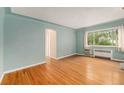 Inviting living area with wood floors, a large window, and serene blue walls at 665 Washington St # 5B, Denver, CO 80203