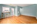 Open living room features hardwood floors, a pass-through to the kitchen, and neutral paint at 665 Washington St # 5B, Denver, CO 80203