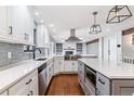 Bright, renovated kitchen boasts stainless appliances, white cabinetry, and modern fixtures at 6330 E Vassar Ave, Denver, CO 80222