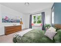 Cozy bedroom with large window seat, neutral walls, and stylish decor at 1106 Oak Cir, Lakewood, CO 80215