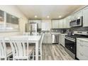 Updated kitchen with stainless steel appliances, modern countertops, and stylish gray cabinets at 6500 E 88Th Ave # 258, Henderson, CO 80640