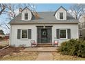 Charming white brick home with gray shutters and a stone walkway at 1601 Leyden St, Denver, CO 80220