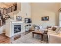 Cozy living room features a stone fireplace, large TV, and comfortable seating, perfect for relaxation at 3181 Firenze Pl, Highlands Ranch, CO 80126
