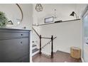 Bright entryway with hardwood floors, a staircase, and decorative accents at 314 Woodstock Ln, Castle Pines, CO 80108