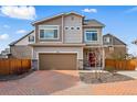 Beautiful two-story home featuring a brick driveway, red front door, and neutral siding at 10123 Zeno St, Commerce City, CO 80022