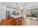 Modern kitchen with island, stainless steel appliances and outside access at 10123 Zeno St, Commerce City, CO 80022