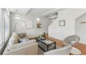 Comfortable living room area with decorative shelving and neutral decor at 10123 Zeno St, Commerce City, CO 80022