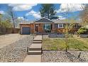 Charming brick home with a cozy front porch and well-maintained front yard landscaping at 882 E Briarwood Cir, Centennial, CO 80122