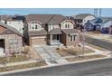Expansive two-story home featuring a welcoming front porch and a spacious driveway at 14667 Crouch Pl, Parker, CO 80134