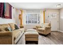 Cozy living room featuring a window and comfortable seating with a small table next to the window at 1734 Kingston St, Aurora, CO 80010