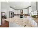 Modern kitchen features granite countertops, stainless steel appliances, and stylish backsplash at 7430 E Bayaud Ave, Denver, CO 80230