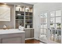 Stylish office space with built-in shelving, hardwood floors, and adjacent dining room with french doors at 7430 E Bayaud Ave, Denver, CO 80230