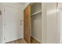 A closet with open wooden doors showcasing the interior and metal shelving, adding convenience at 13606 E Bates Ave # 304, Aurora, CO 80014