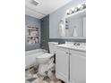 Modern bathroom featuring tub with stylish gray tile, toilet and vanity at 2281 Vaughn # 104A, Aurora, CO 80014