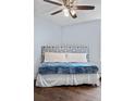 Comfortable bedroom featuring a ceiling fan, and blue accent bedding atop the comfortable bed at 2281 Vaughn # 104A, Aurora, CO 80014