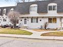 Cozy townhomes featuring stucco exterior with grey roof, walkway, and quaint lawns in a well-maintained community at 421 E Highline Cir, Centennial, CO 80122