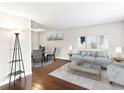 Inviting living room featuring hardwood floors, modern gray sofa, neutral paint, and a bright and airy ambiance at 421 E Highline Cir, Centennial, CO 80122