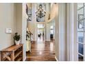 Grand entryway with soaring ceilings, elegant chandelier, and beautiful hardwood floors at 22475 E Hidden Trail Dr, Parker, CO 80138