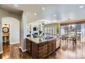 Well-lit kitchen island with granite countertops and views of the dining and living areas at 22475 E Hidden Trail Dr, Parker, CO 80138