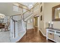 Grand foyer featuring a curved staircase, hardwood floors, and soaring ceilings at 2618 Bellavista St, Castle Rock, CO 80109