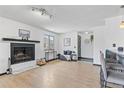 Open-concept living area with a cozy fireplace, large window, and stylish decor at 6680 E Mississippi Ave # 3, Denver, CO 80224