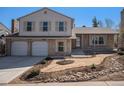 Charming two-story home with a brick and siding exterior, a two-car garage, and a well-maintained front yard at 7852 S Logan St, Littleton, CO 80122