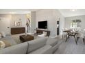 Bright living room and dining area featuring modern decor and hardwood flooring at 7852 S Logan St, Littleton, CO 80122