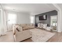 Bright and airy living room with plush seating, modern decor, and ample natural light at 9862 Reunion Pkwy, Commerce City, CO 80022